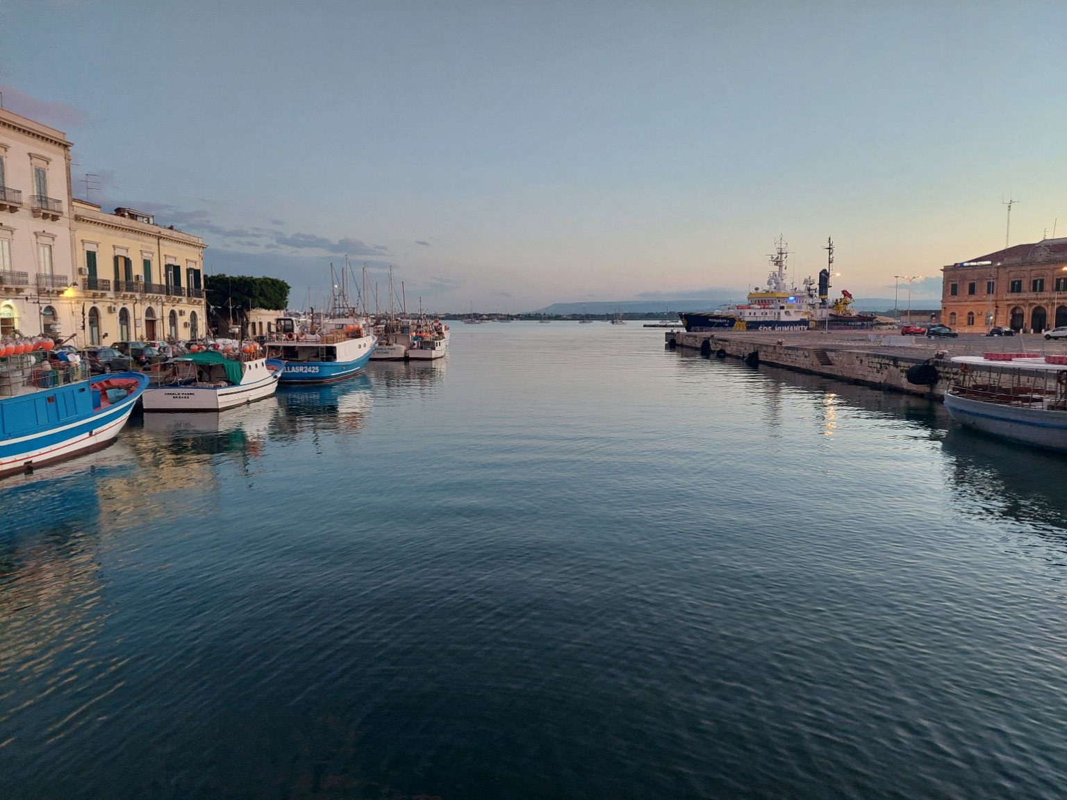 Fishing boats in a Sicilian harbor at dusk